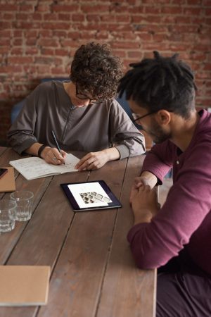 man-wearing-purple-long-sleeved-shirt-looking-at-the-ipad-3184326